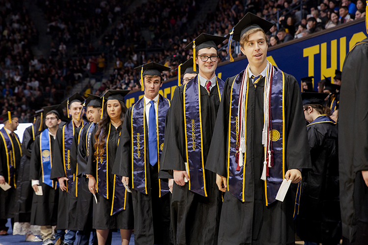 Students wait in line to receive their diplomas during UC Berkeley's Winter Commencement Ceremony at Haas Pavilion on Saturday, Dec. 21, 2019.
